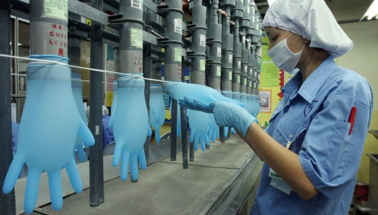 Malaysia to take glovemaker to court for not paying workers